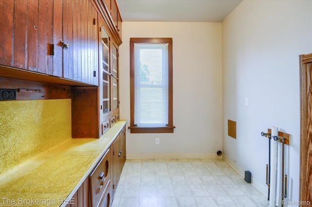9425 W Saginaw Rd, Richville, MI 48758 - laundry room featuring cabinet space, plenty of natural light, and baseboards