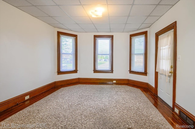 9425 W Saginaw Rd, Richville, MI 48758 - spare room featuring dark wood-style floors, a drop ceiling, and baseboards