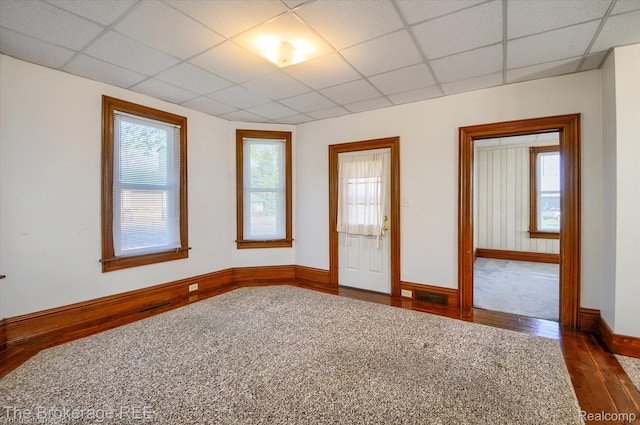 9425 W Saginaw Rd, Richville, MI 48758 - empty room with dark wood-style floors, baseboards, and a paneled ceiling