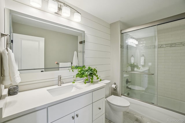 6652 Westminister St, Fenton, MI 48430 - full bath featuring marble look tile flooring, vanity, shower / bath combination with glass door, toilet, and wood walls