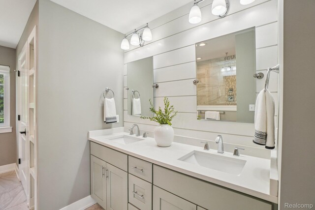 6652 Westminister St, Fenton, MI 48430 - bathroom featuring double vanity, baseboards, a tile shower, and marble look tile flooring
