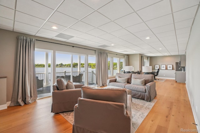6652 Westminister St, Fenton, MI 48430 - living area featuring a drop ceiling, light wood-type flooring, baseboards, recessed lighting, and a water view
