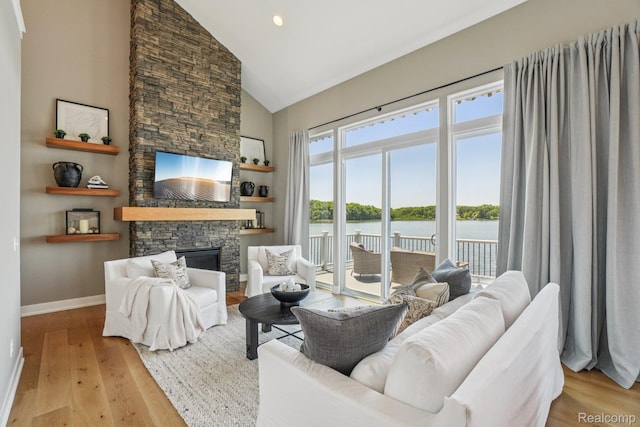 6652 Westminister St, Fenton, MI 48430 - living room with high vaulted ceiling, a stone fireplace, hardwood / wood-style flooring, baseboards, and recessed lighting