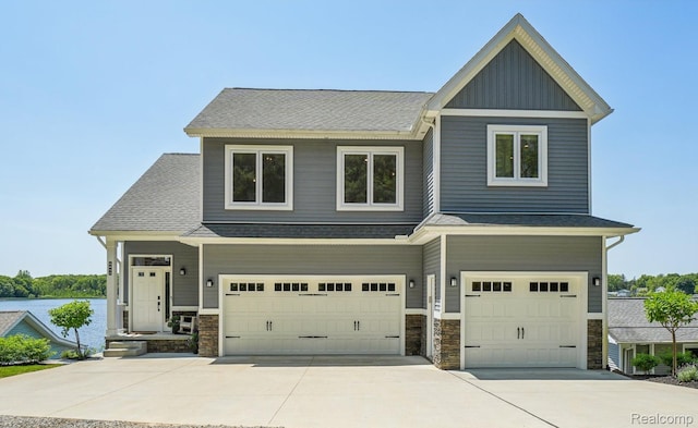 6652 Westminister St, Fenton, MI 48430 - craftsman-style house featuring a garage, stone siding, concrete driveway, and roof with shingles