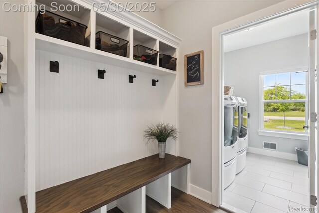 4925 Toratola Ln, Howell, MI 48843 - mudroom with separate washer and dryer, baseboards, and tile patterned flooring