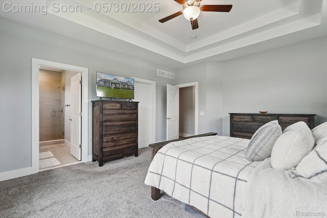 4925 Toratola Ln, Howell, MI 48843 - bedroom with carpet flooring, a tray ceiling, connected bathroom, a ceiling fan, and baseboards
