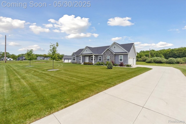 4925 Toratola Ln, Howell, MI 48843 - craftsman-style house featuring a front yard and driveway