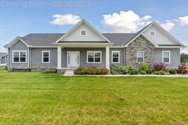 4925 Toratola Ln, Howell, MI 48843 - craftsman-style house with board and batten siding, a front lawn, and stone siding