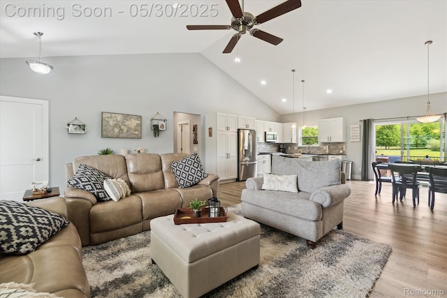 4925 Toratola Ln, Howell, MI 48843 - living room with ceiling fan, high vaulted ceiling, light wood finished floors, and recessed lighting