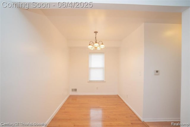 23060 Berdeno Ave, Hazel Park, MI 48030 - spare room featuring a chandelier, light wood-style flooring, and baseboards