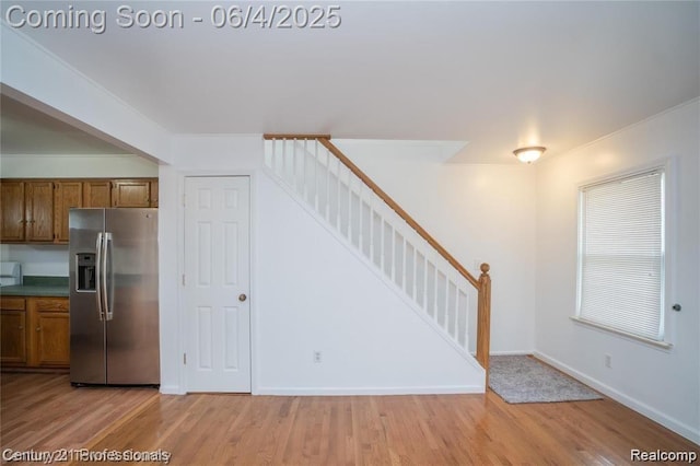 23060 Berdeno Ave, Hazel Park, MI 48030 - kitchen featuring stainless steel refrigerator with ice dispenser, brown cabinets, light wood finished floors, baseboards, and dark countertops