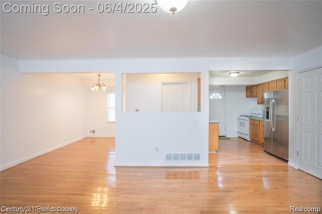 23060 Berdeno Ave, Hazel Park, MI 48030 - unfurnished living room featuring a chandelier, light wood-style flooring, and baseboards