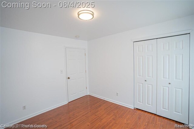23060 Berdeno Ave, Hazel Park, MI 48030 - unfurnished bedroom featuring wood finished floors, a closet, and baseboards