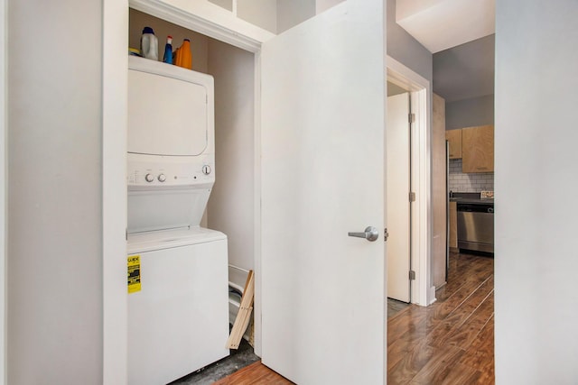 2159 New Town Dr NE, Grand Rapids, MI 49525 - washroom featuring stacked washer / dryer and wood finished floors