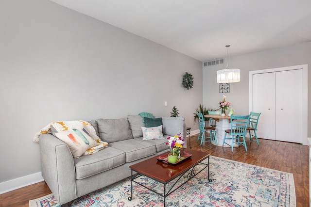 2159 New Town Dr NE, Grand Rapids, MI 49525 - living area with baseboards, wood finished floors, and a chandelier