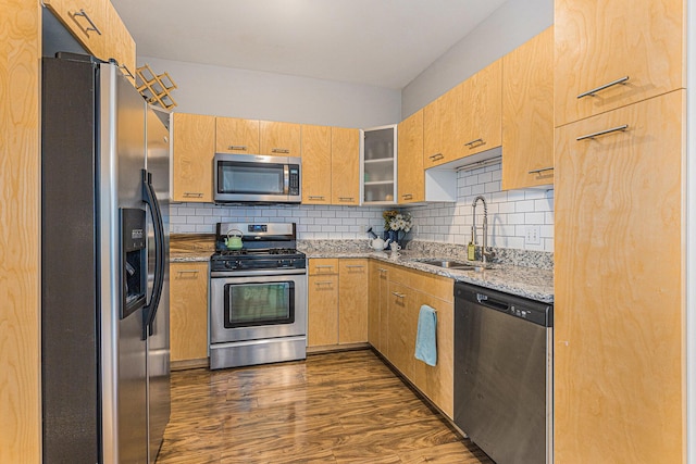 2159 New Town Dr NE, Grand Rapids, MI 49525 - kitchen featuring stainless steel appliances, a sink, light stone countertops, tasteful backsplash, and dark wood finished floors