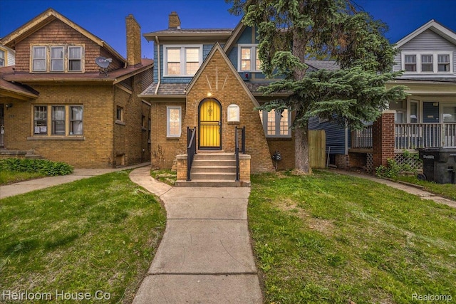 16514 Wildemere St, Detroit, MI 48221 - english style home featuring a front lawn, a chimney, and brick siding