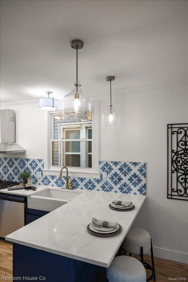 16514 Wildemere St, Detroit, MI 48221 - kitchen featuring a sink, dishwasher, backsplash, and wood finished floors