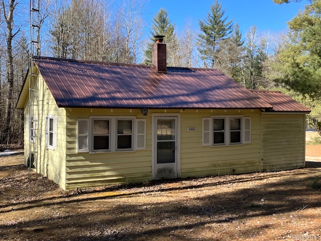 5400 Allen Rd, Alger, MI 48610 - view of front of house with a chimney and metal roof