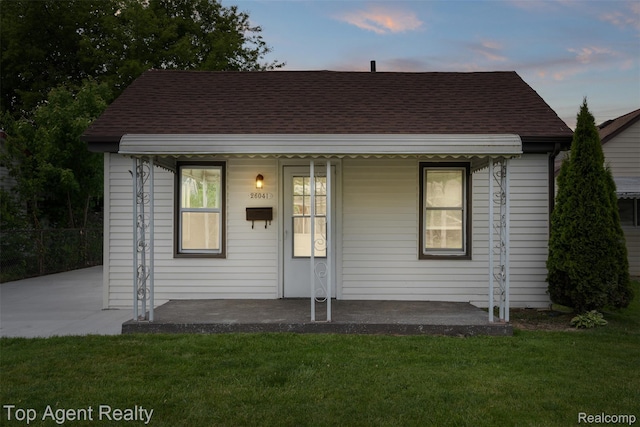 26041 Belanger St, Rochester, MI 48066 - bungalow with covered porch, a front lawn, and a shingled roof