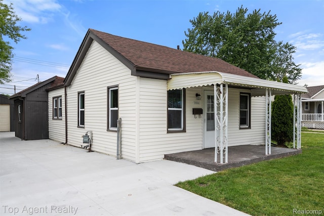 26041 Belanger St, Rochester, MI 48066 - view of front facade featuring a porch, a front yard, concrete driveway, and roof with shingles