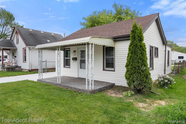 26041 Belanger St, Rochester, MI 48066 - view of front of house featuring covered porch, a front yard, and roof with shingles