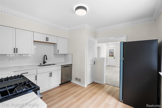 26041 Belanger St, Rochester, MI 48066 - kitchen with appliances with stainless steel finishes, a sink, light wood-type flooring, white cabinetry, and tasteful backsplash