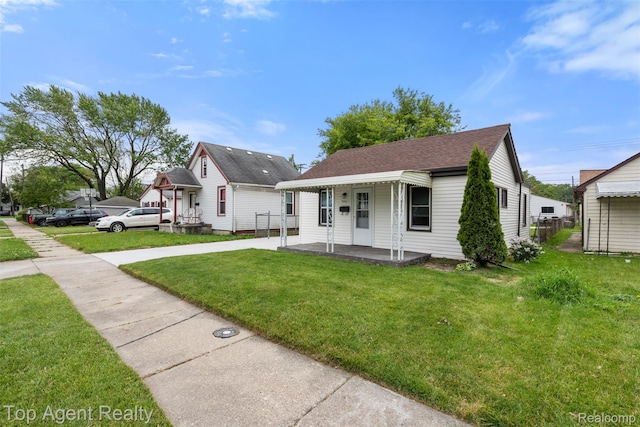 26041 Belanger St, Rochester, MI 48066 - view of front of home with a porch, a front lawn, roof with shingles, and concrete driveway