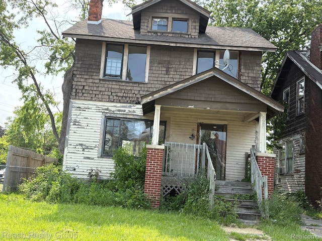 12859 Hubbell St, Detroit, MI 48227 - traditional style home with a porch, a chimney, and a shingled roof
