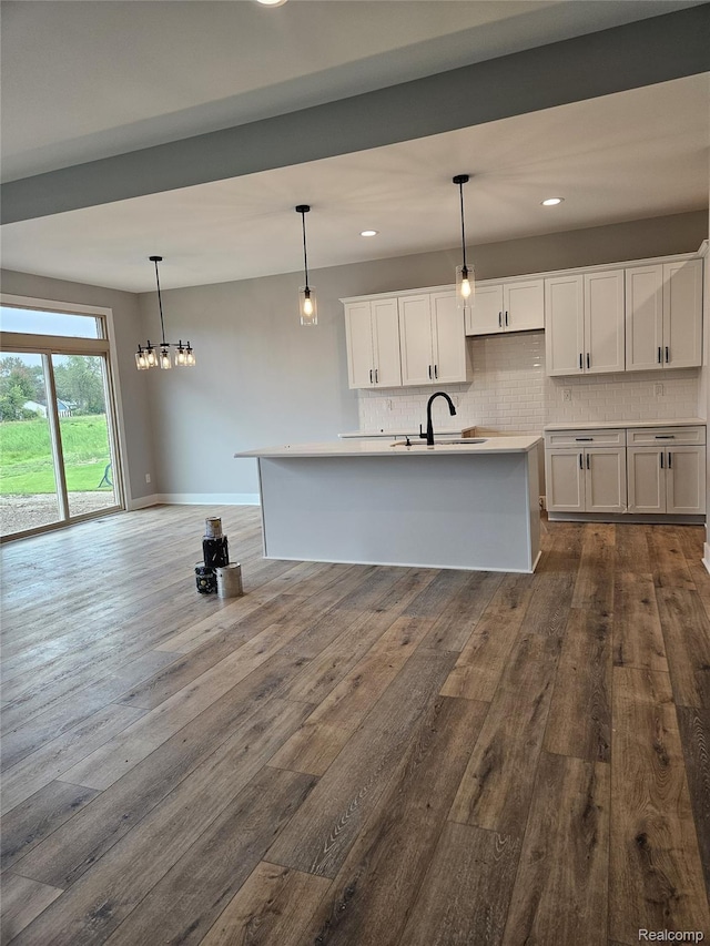 3059 Regatta Dr, St, MI 48079 - kitchen with a sink, backsplash, white cabinets, dark wood-style flooring, and pendant lighting