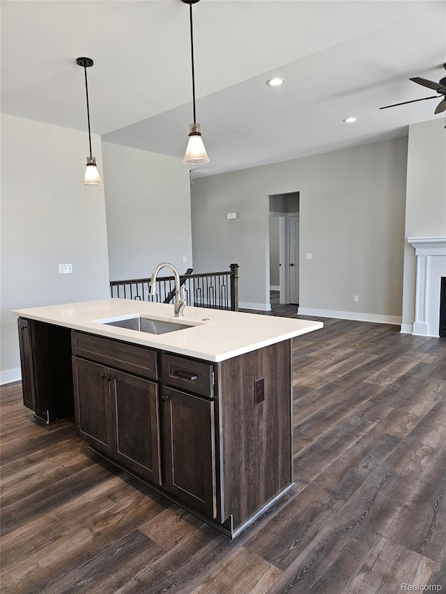 3059 Regatta Dr, St, MI 48079 - kitchen featuring a sink, dark wood-style floors, open floor plan, dark brown cabinetry, and recessed lighting