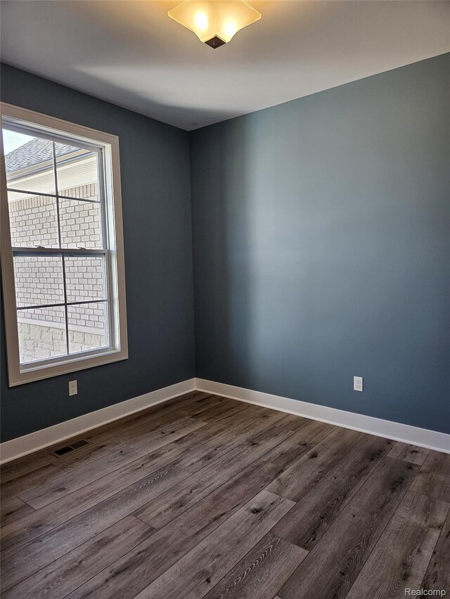 3059 Regatta Dr, St, MI 48079 - spare room with dark wood-style floors and baseboards