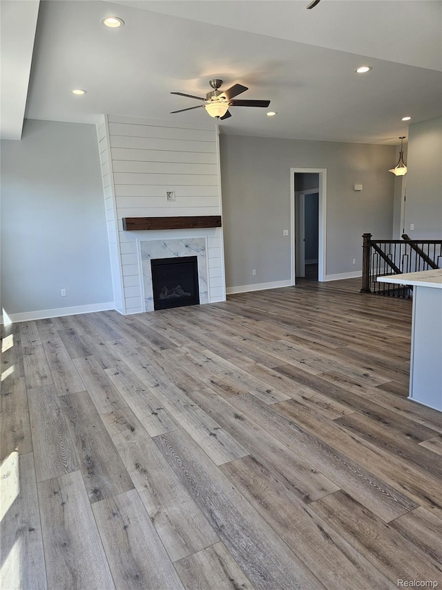 3059 Regatta Dr, St, MI 48079 - unfurnished living room featuring a ceiling fan, wood finished floors, recessed lighting, baseboards, and a high end fireplace