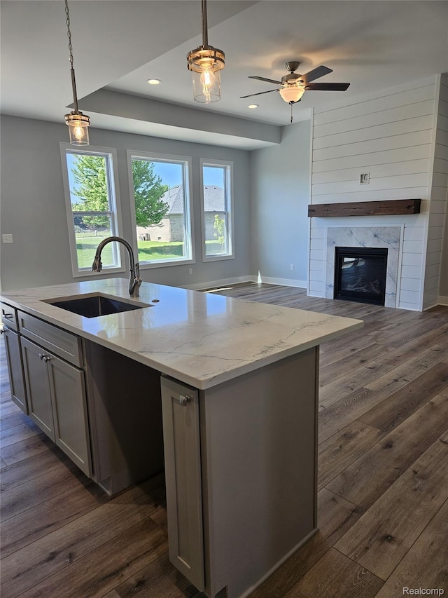 3059 Regatta Dr, St, MI 48079 - kitchen with a sink, dark wood-style floors, open floor plan, a kitchen island with sink, and gray cabinets