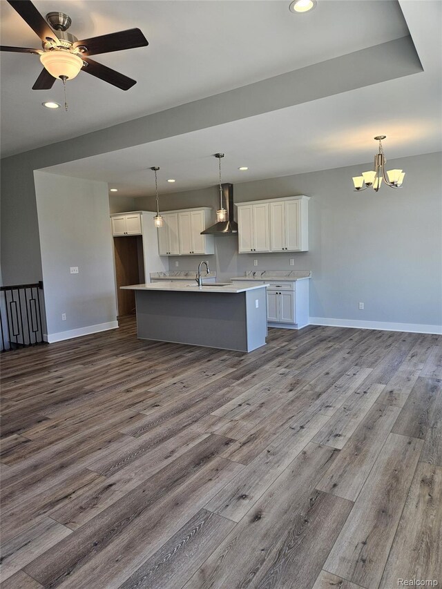 3059 Regatta Dr, St, MI 48079 - kitchen featuring wall chimney range hood, recessed lighting, an island with sink, white cabinetry, and dark wood-style floors