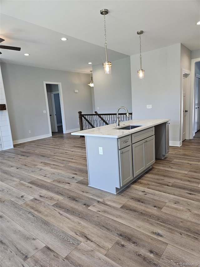 3059 Regatta Dr, St, MI 48079 - kitchen with a sink, gray cabinetry, open floor plan, wood finished floors, and recessed lighting
