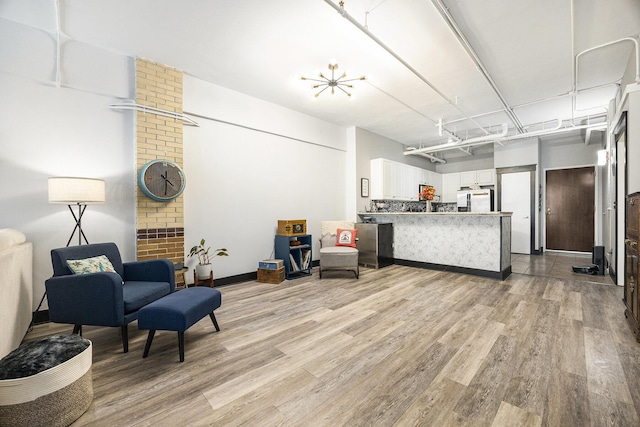 600 Broadway Ave NW Unit 117, Grand Rapids, MI 49504 - living area with light wood-style flooring and baseboards