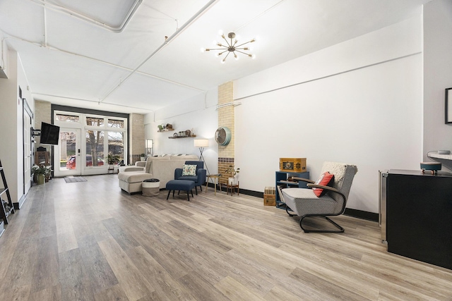 600 Broadway Ave NW Unit 117, Grand Rapids, MI 49504 - living area with light wood-style floors and french doors