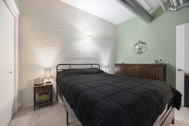 600 Broadway Ave NW Unit 117, Grand Rapids, MI 49504 - bedroom with light colored carpet and brick wall