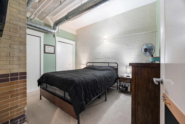 600 Broadway Ave NW Unit 117, Grand Rapids, MI 49504 - carpeted bedroom with brick wall