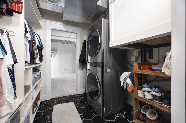 600 Broadway Ave NW Unit 117, Grand Rapids, MI 49504 - laundry area with stacked washing machine and dryer and dark colored carpet