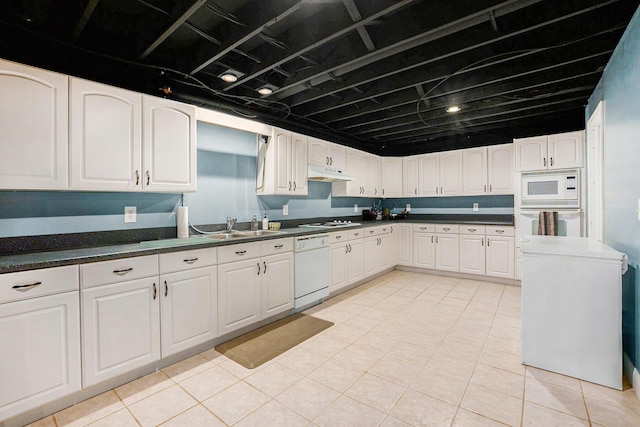 2032 Dean Dr, Washington, MI 48094 - kitchen featuring white appliances, under cabinet range hood, dark countertops, and white cabinetry