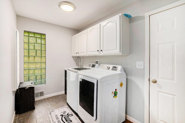 2032 Dean Dr, Washington, MI 48094 - laundry area featuring cabinet space, washer and dryer, and light tile patterned floors