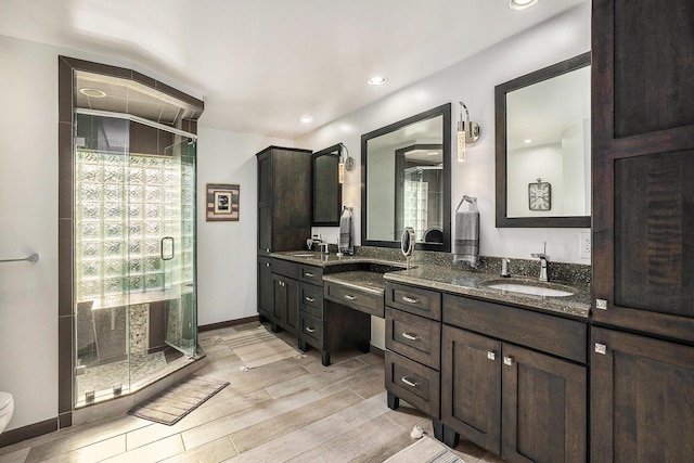 2032 Dean Dr, Washington, MI 48094 - bathroom featuring a shower stall, double vanity, wood finished floors, and recessed lighting