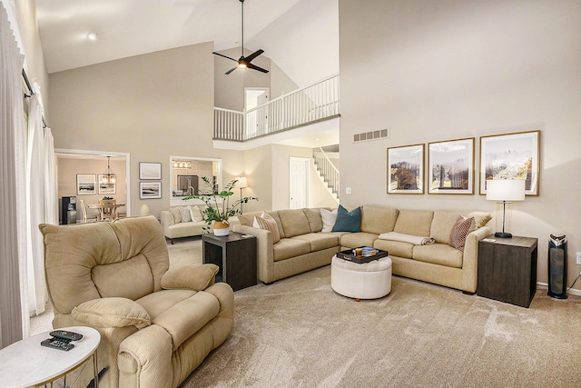 2032 Dean Dr, Washington, MI 48094 - carpeted living room with high vaulted ceiling, stairs, and ceiling fan
