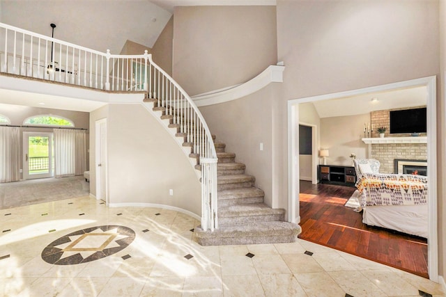 2032 Dean Dr, Washington, MI 48094 - stairway with a towering ceiling and a brick fireplace