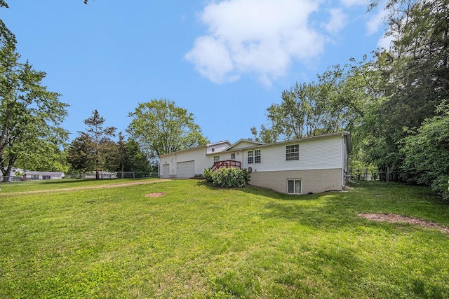 149 Hall St, Michigan Center, MI 49254 - rear view of house featuring a lawn, a garage, and driveway