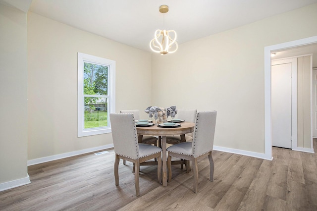 320 Calhoun St, Union City, MI 49094 - dining space with wood finished floors, a chandelier, and baseboards