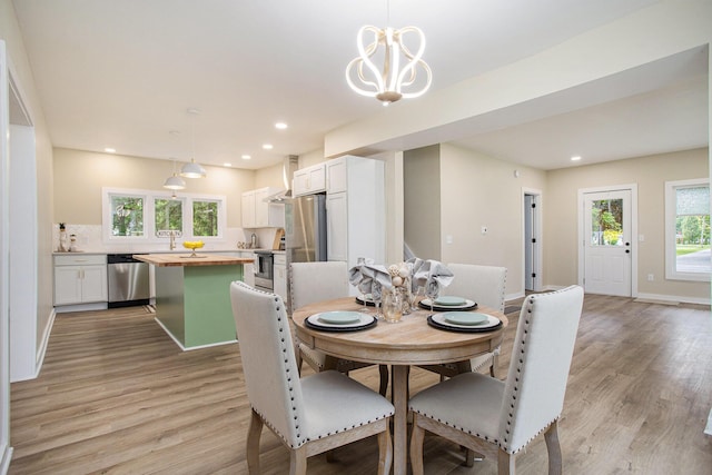320 Calhoun St, Union City, MI 49094 - dining room with light wood-style flooring, baseboards, recessed lighting, and a chandelier