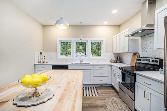 320 Calhoun St, Union City, MI 49094 - kitchen with stainless steel electric range oven, wall chimney range hood, a sink, wooden counters, and wood finished floors